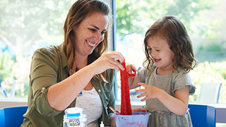 Child life specialist doing crafts with young girl