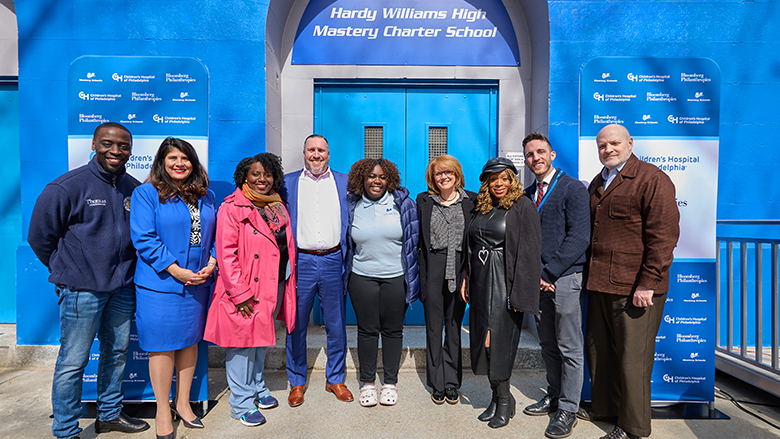Representatives from Mastery Schools, Children’s Hospital of Philadelphia and Bloomberg Philanthropies standing in front of the entrance to Hardy Williams High Mastery Charter School