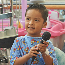 Young boy holding microphone