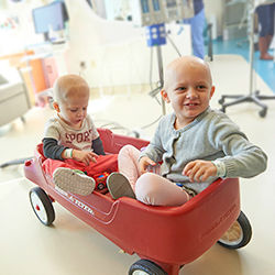 Two kids with cancer in a wagon at KOP Specialty Care Center