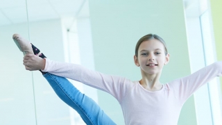 Young girl doing ballet stretch