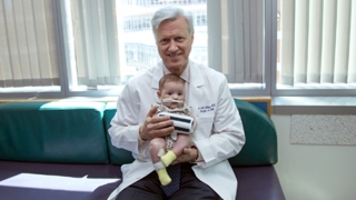 Dr Adzick holding a baby with HI