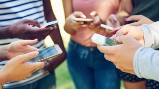 Teens messaging on mobile phones