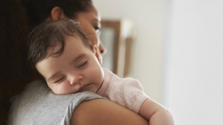 Mother holding sleeping infant