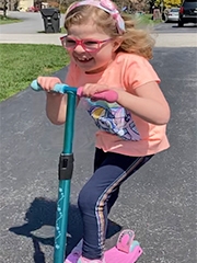 Josie riding a scooter