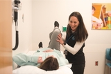 Physical therapist treating hip injury.