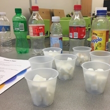 Soft drink bottles and cups of sugar cubes