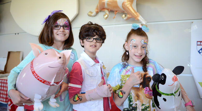 Girls holding balloons and smiling at the 2017 Best Friends Bash