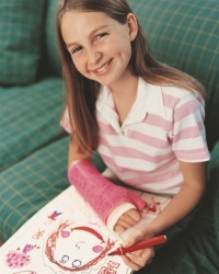 Young girl wearing a cast on her arm