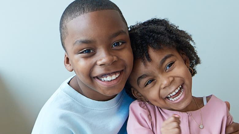 Siblings Zuri and Zion smiling