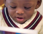 Baby reading a book.