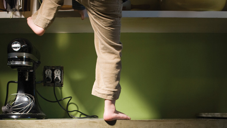 Boy climbing on counter