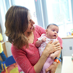 Mom holding daughter infant