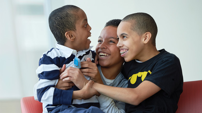 Mom with 2 sons smiling