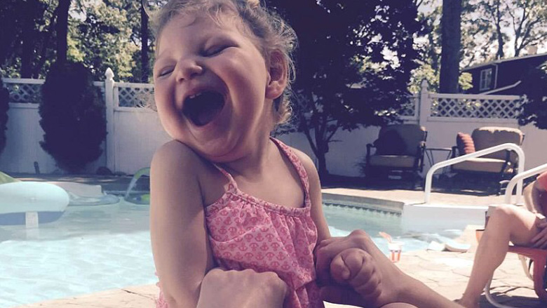 Camryn smiling by the pool