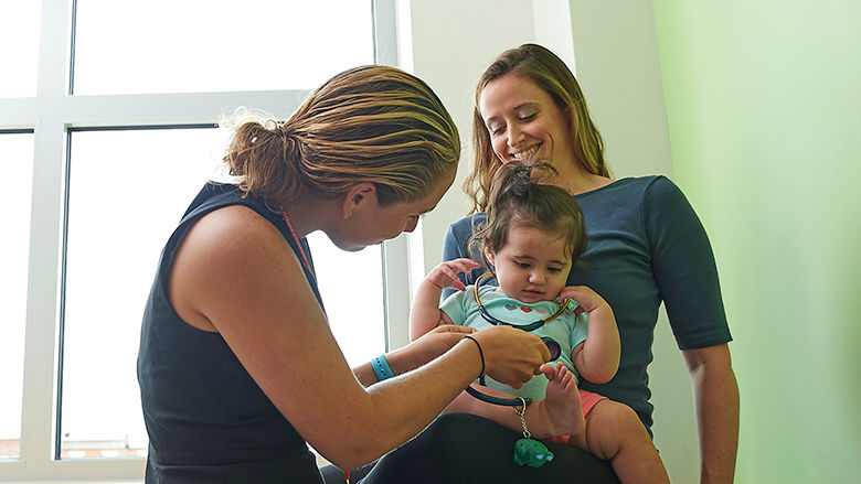 Mom with toddler daughter at pediatrician