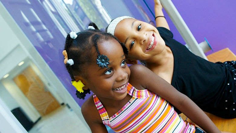 Two young girls smiling
