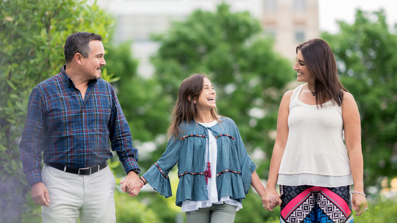 Paulina walking outside with her parents