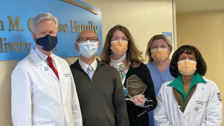 Group photo of CFDT team holding award