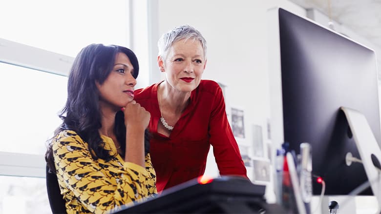 Woman mentoring younger woman Woman mentoring younger woman