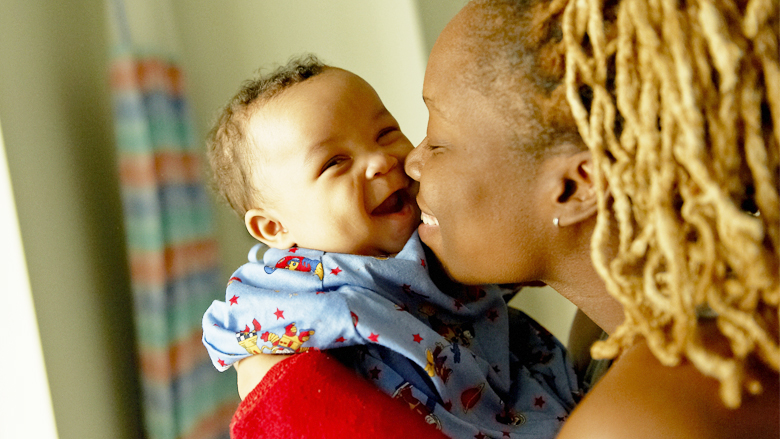 Mother kissing baby son Mother kissing baby son