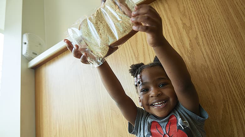 Child holding a sandwich