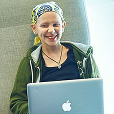 Girl with cancer using a laptop