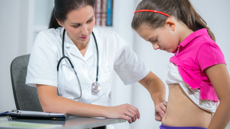 Doctor examining a child's stomach