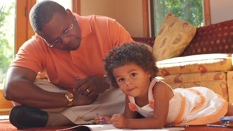 father sitting with young daughter