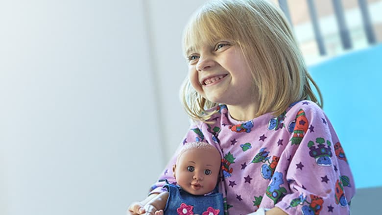 Young patient holding teddy bear