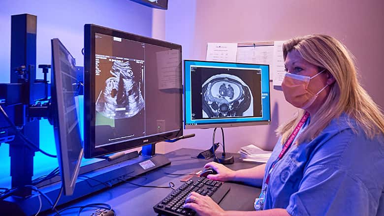 Fetal specialist reviews MRIs on computer screen