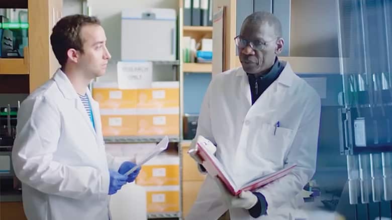 Two workers in genomics lab