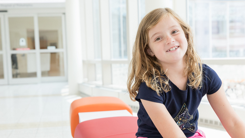 Hannah sitting and smiling