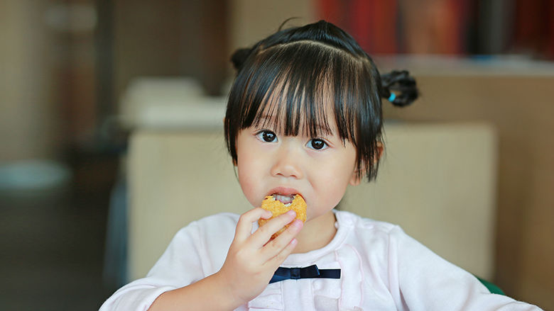 Girl eating chicken nugget