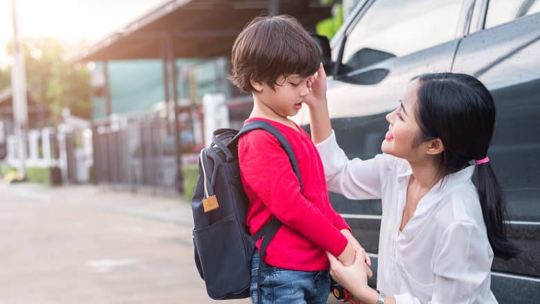 Mother with son holding backpack