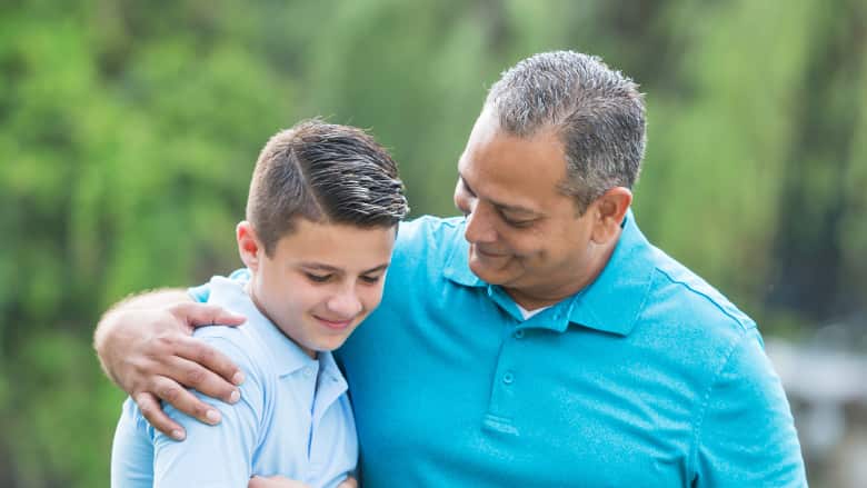 Father with arm around son