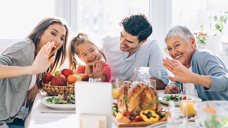 Family doing a video call at Thanksgiving table