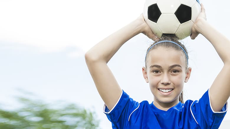 GIrl holding soccer ball