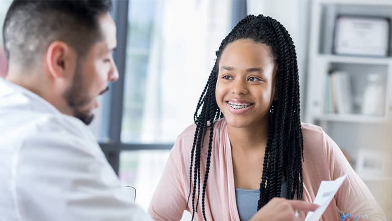 Doctor talking to teen patient