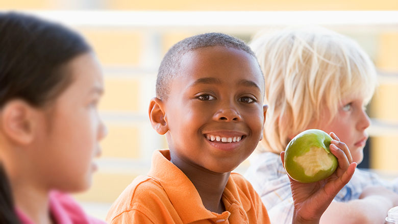 Young boy holding an apple