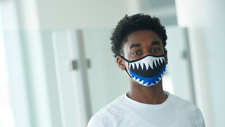 Teenager wearing a mask Teenager wearing a mask