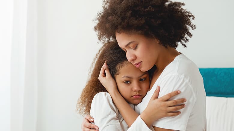 Mother hugging distraught daughter Mother hugging distraught daughter