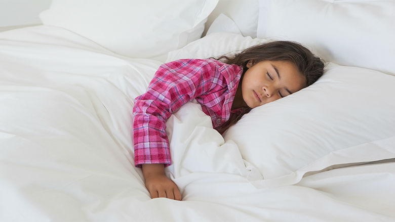 Older female toddler sleeping in bed