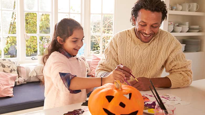 Father and daughter making Halloween crafts Father and daughter making Halloween crafts
