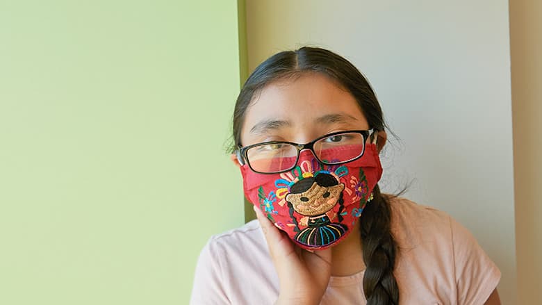 Teen girl wearing a protective mask Teen girl wearing a protective mask