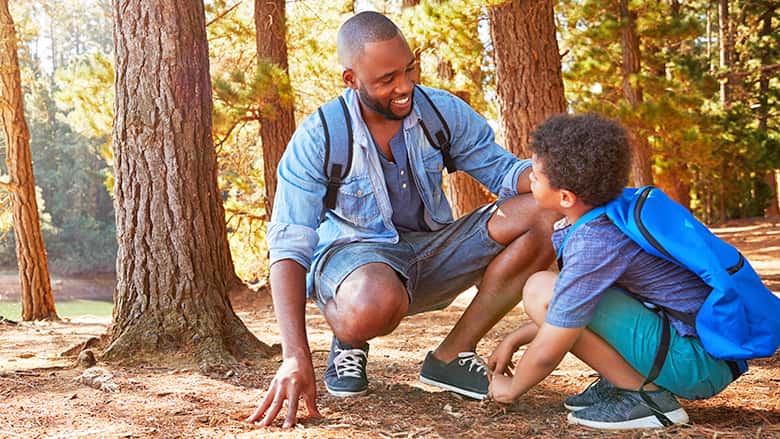 Father and son hiking in the woods