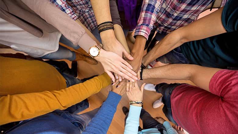 Diverse group of hands coming together