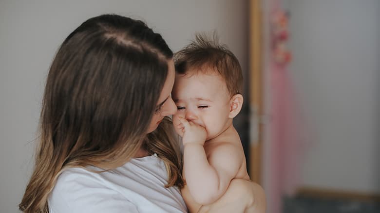 Mother holding sick baby