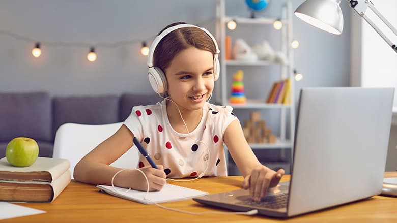 Young girl attending online school course Young girl attending online school course