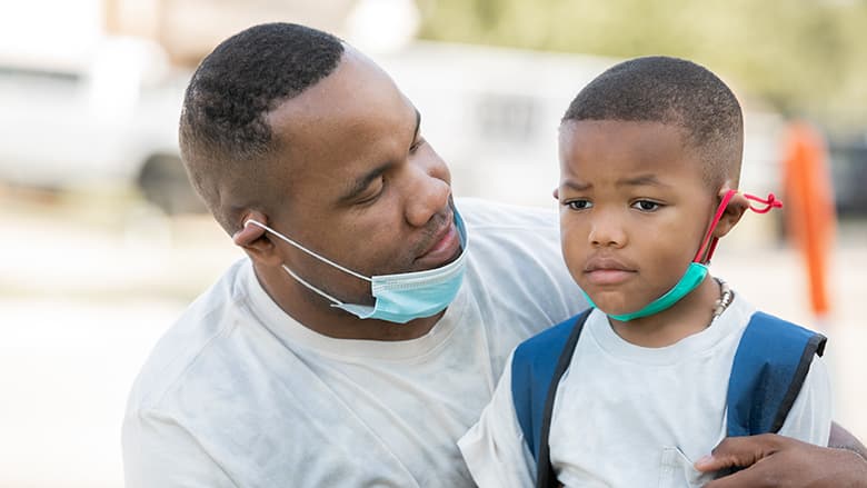 Father consoling young son